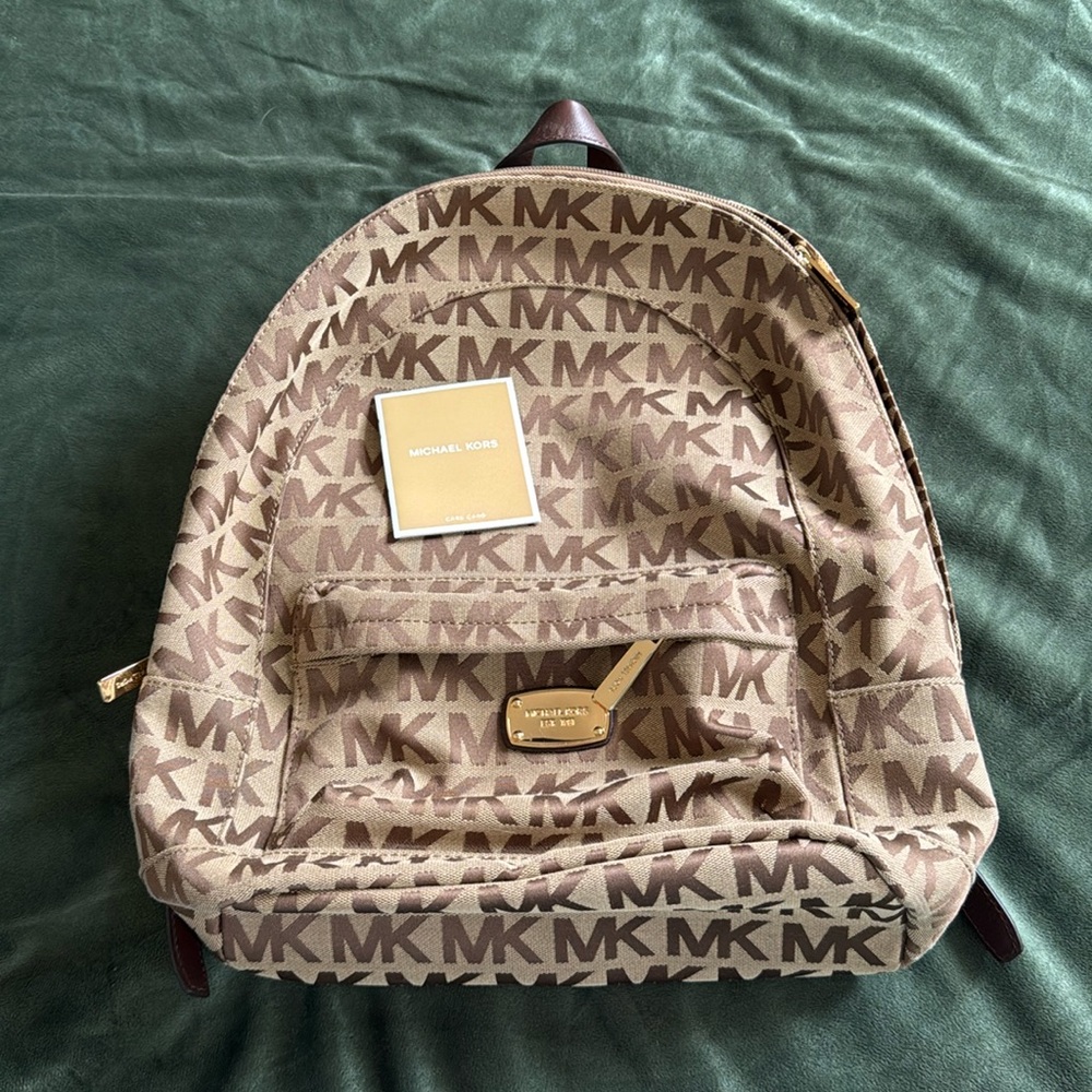 Michael Kors Brown Logo Backpack, Brown Leather straps and gold buckles.